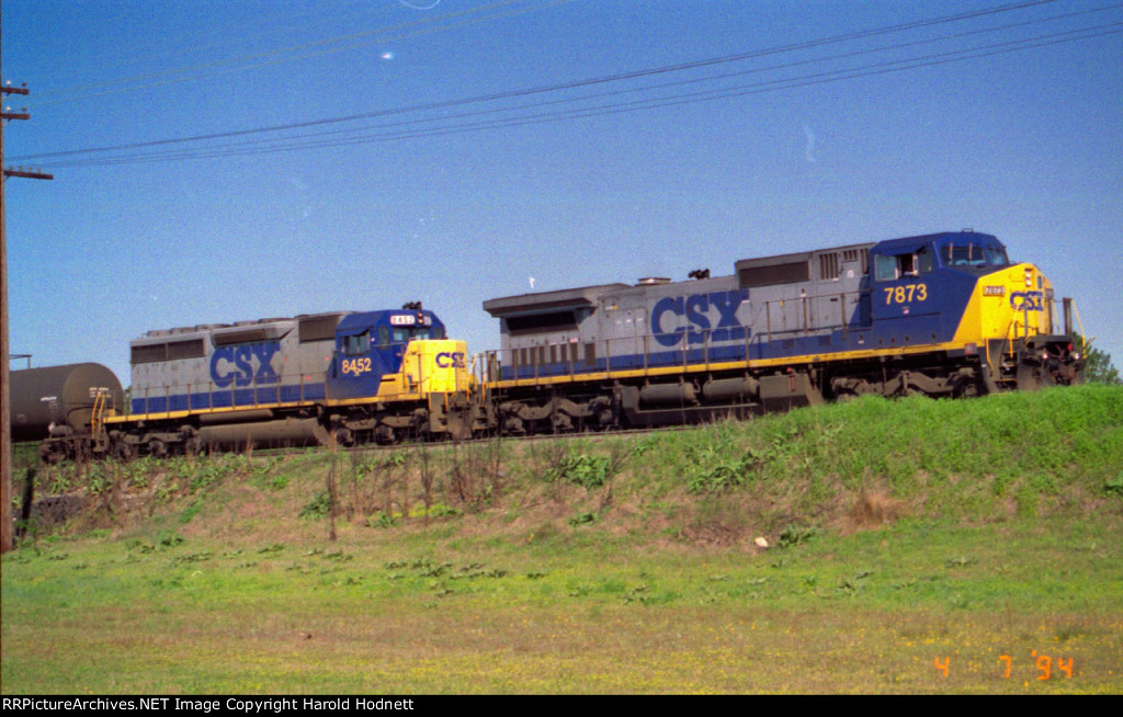 CSX 7873 & 8452 lead a train southbound out of the yard